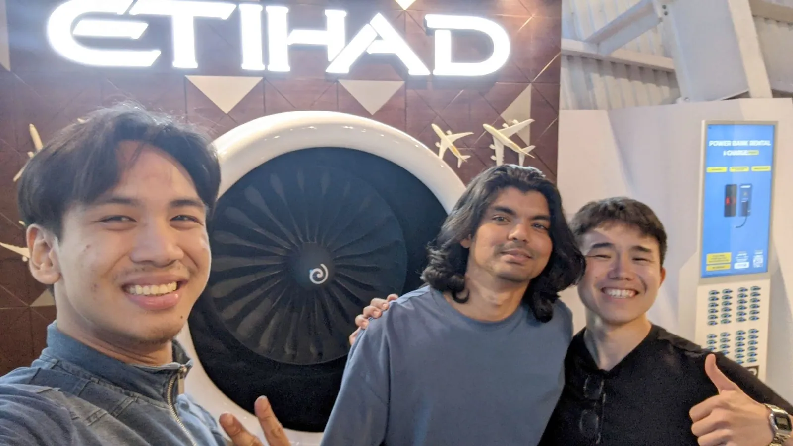 Belli team members in front of an Etihad aircraft engine display